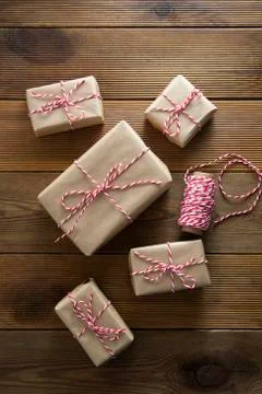 Christmas background. Gift boxes wraped in craft paper over wooden background Stock-Fotos