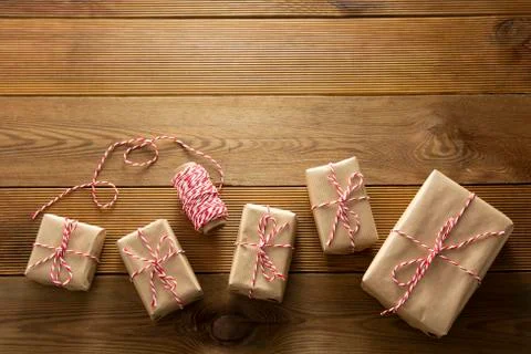 Christmas background. Gift boxes wraped in craft paper over wooden background Stock-Fotos