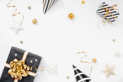 Christmas background. Gifts, party hats, black and golden decorations on white Stock Photos