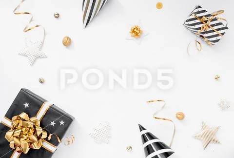 Christmas background. Gifts, party hats, black and golden decorations on white Stock-Fotos