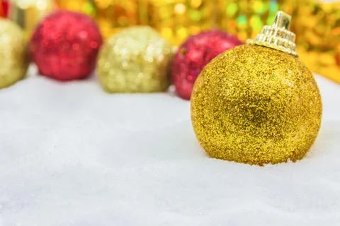 Christmas background with a golden gift box in snow Stock Photos