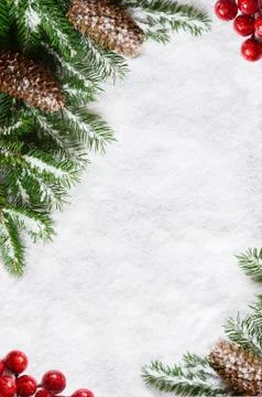 Christmas background, green pine branches, cones on snow background. Creative Foto stock