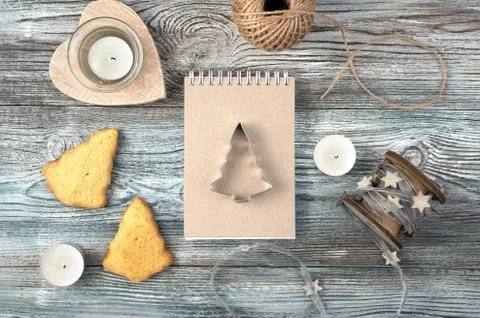 Christmas background with Notepad, iron shape of Christmas tree, cookies and Stock Photos