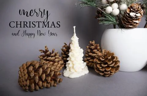Christmas background with pine cones and candle in the shape of a fir tree M Stock Photos
