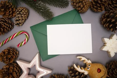 Christmas background pine cones, candy, star, snowflakes with green envelope Stock Photos