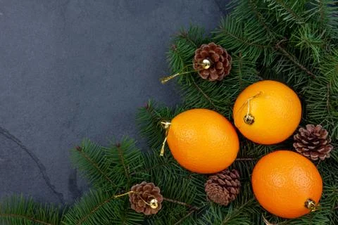 Christmas background with pine tree cones, pine tree branches and oranges. zero Fotos de archivo