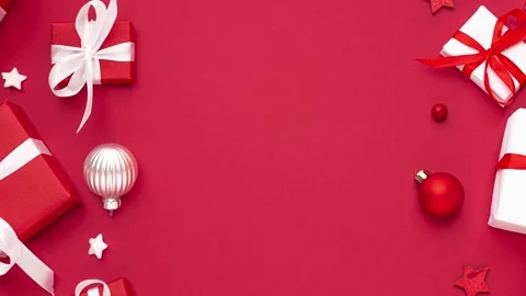 Christmas background. Red and white gift boxes with Christmas decorations on red Stock Footage 288736660
