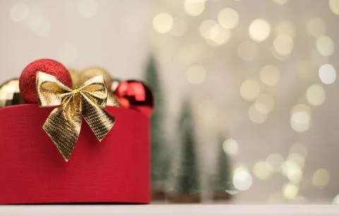 Christmas background , red gift box with a Golden bow on the background of Ch Stock Photos