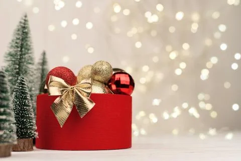 Christmas background , red gift box with a Golden bow on the background of Ch Stock Photos