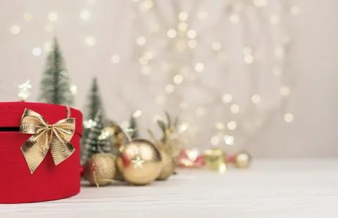 Christmas background , red gift box with a Golden bow on the background of Ch Stock Photos