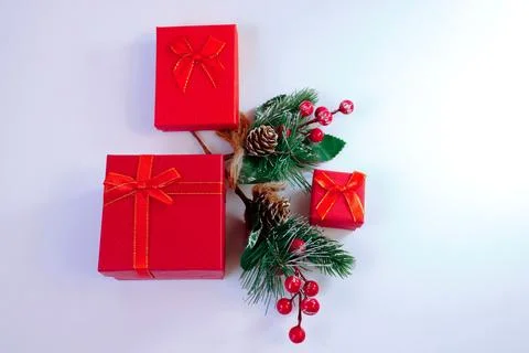 Christmas background with red gift boxes wrapped in ribbon and pine branches Stock Photos