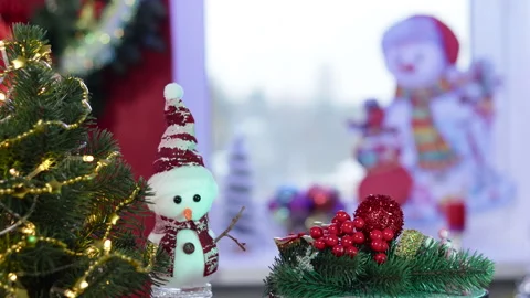 On a Christmas background on a stand with rotating decorations near a snowman Stock Footage 257659933
