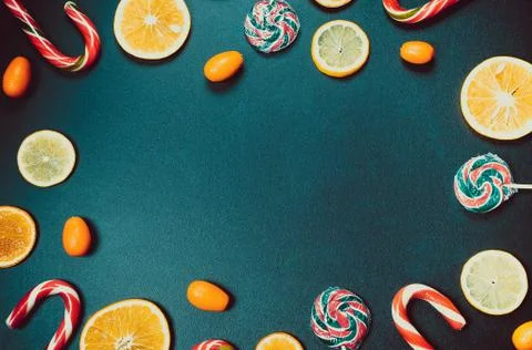 Christmas background with sweets, candy and gingerbread with oranges, lemons  Stock Photos