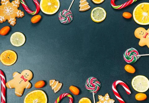 Christmas background with sweets, candy and gingerbread with oranges, lemons  Stock Photos