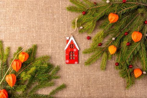 Christmas background with the texture of burlap, tree branches and toys Stock Photos