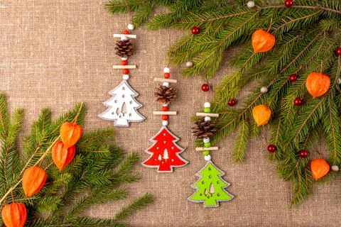 Christmas background with the texture of burlap, tree branches and toys Photos