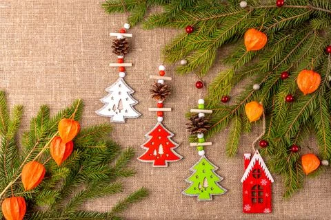 Christmas background with the texture of burlap, tree branches and toys Photos