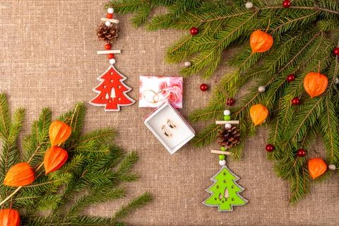 Christmas background with the texture of burlap, tree branches and toys Stock Photos
