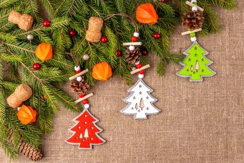 Christmas background with the texture of burlap, tree branches and toys Stock Photos