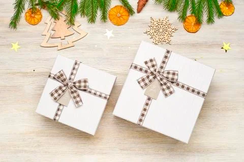 Christmas background. Two gift box with bow of different sizes. The branches  Stock Photos