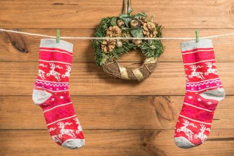 Christmas background with two red socks placed on a rope. Stock Photos