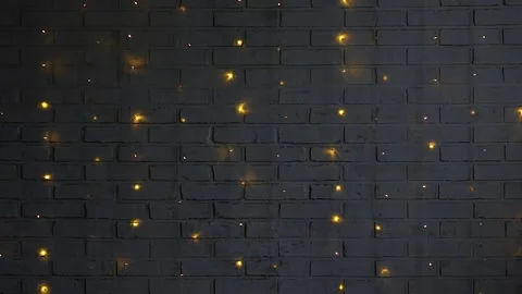 Christmas background - white brick wall with lights in darkness Stock Footage 185929297