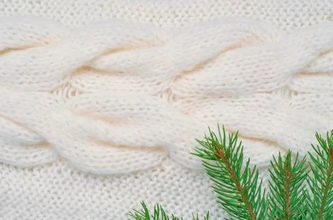 Christmas background white knitting pattern and spruce branches Stock Photos