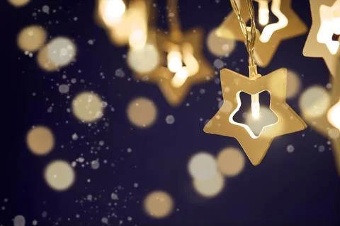 Christmas backgrounds. Small decorative Christmas stars light with bokeh ligh Stock Photos