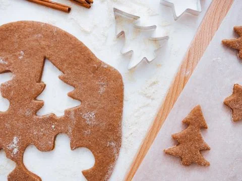 Christmas baking background: dough, cookie cutters and spices. Viewed from above Stock Photos