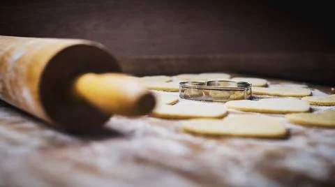 Christmas baking. Making gingerbread biscuits. Cookie dough and cookie cutters. Stock Photos