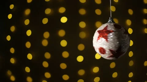 Christmas ball on the background blinking blurred garland. Video stock 144470682