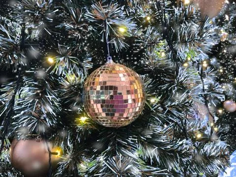 Christmas ball hanging on tree with snow effect Stock Photos