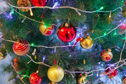 A Christmas ball hangs on the background of a clock. It's time for a new year Foto stock