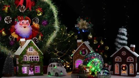 Christmas balls of different sizes rotate against the background of houses Stock-Footage 279798346