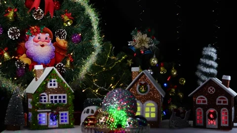 Christmas balls of different sizes spinning against the background of houses Video stock 279798351