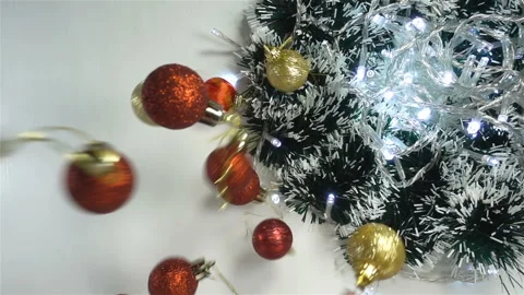 Christmas balls falling in slow motion on the glowing garlands Stock Footage 142078567