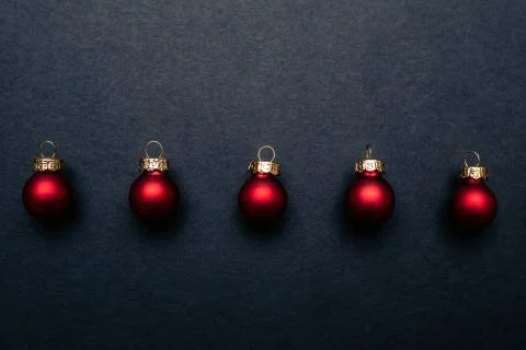 Christmas balls flat layout on dark background. Stock Photos
