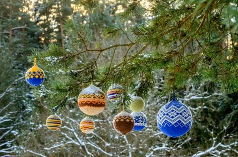 Christmas balls hanging on pine branches covered with snow Stock Photos