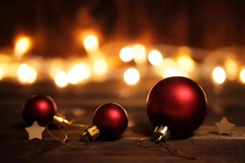 Christmas balls for a tree on a wooden background with a garland Stock Photos