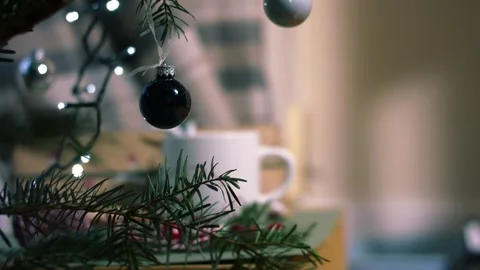 Christmas bauble on tree with hot drink in background Stock Footage 326359761