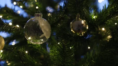 A Christmas bauble with white snowflake patterns hangs on a green fir branch Stock Footage 324920804