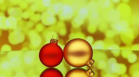 Christmas baubles rotating on reflective surface Stock Footage 8963402