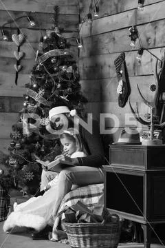 Christmas bearded father and girl reading Stock Photos