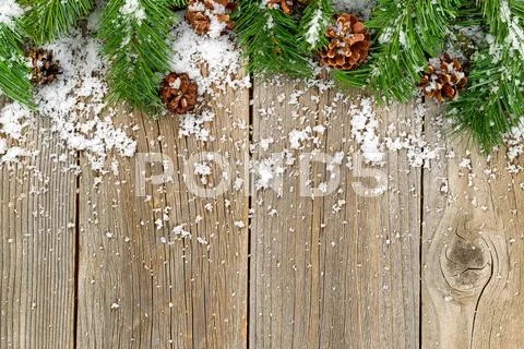 Christmas Border Decorations With Snow On Rustic Wooden Boards