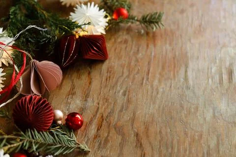 Christmas border. Festive side border of paper ornaments, glass finials, re.. Stock Photos