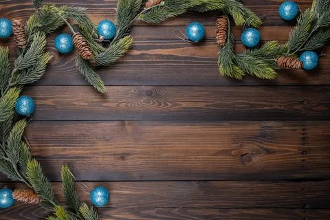 Christmas border pine branches with blue ornaments on wood Stock Photos