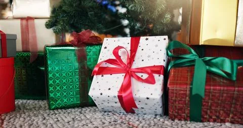 Christmas, boxes and gift by tree in home with ribbon for celebration, tradition Stock Photos