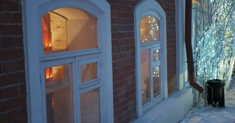 Christmas. The branches of the tree placed next to the glowing windows. Vídeos de archivo 296103491