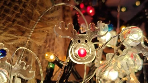 Christmas bright glare of multi-colored lights under the tree close-up macro pho Видео 322675679