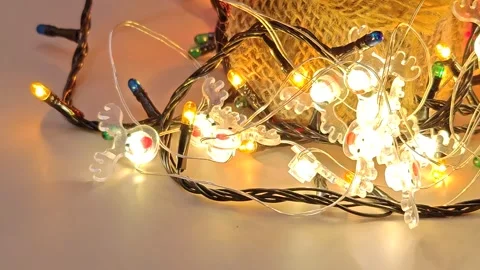Christmas bright glare of multi-colored lights under the tree yellow background Stock Footage 322675682